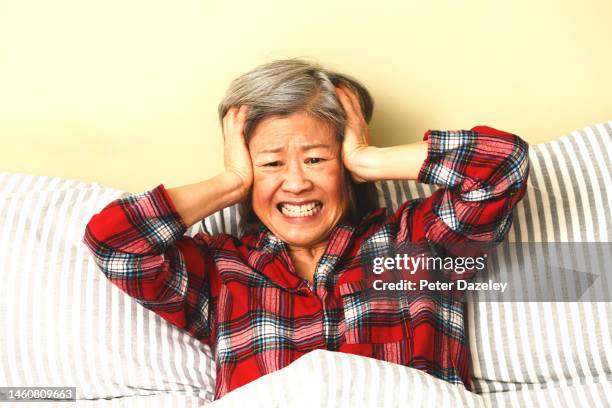 woman, despair, head in hands in bed - shock stock pictures, royalty-free photos & images