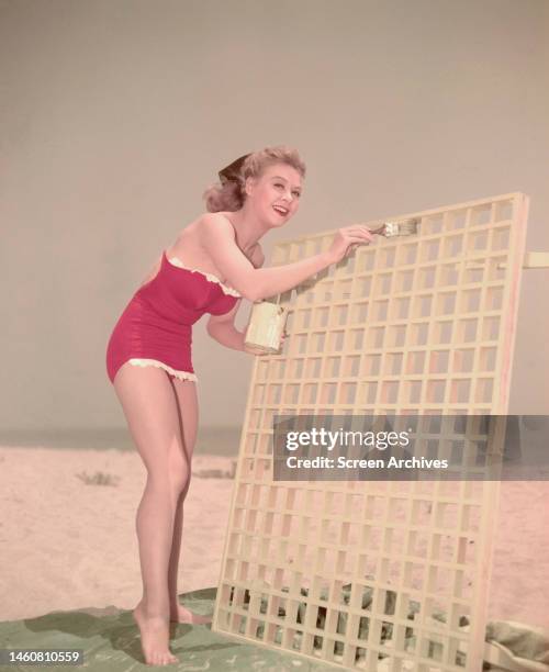 American dancer and actress Vera-Ellen american on a beach wearing red swimsuit, circa 1945.