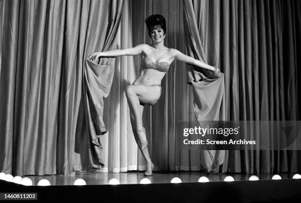 Natalie Wood performing a burlesque striptease act in a scene from 'Gypsy', 1961.