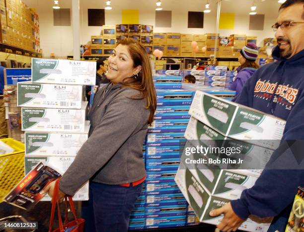 Holiday shoppers Monica Martinez, 35 from Whittier, CA and Gilbert Viveros, 32 from Downey, CA stock up on DVD players at an early-bird sale at Best...