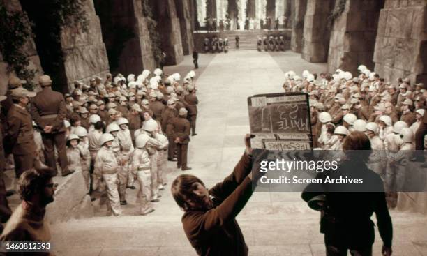 Director George Lucas on set during the filming of Star Wars: Episode IV - A New Hope', 1977. The clapper board displays the working title 'The Star...