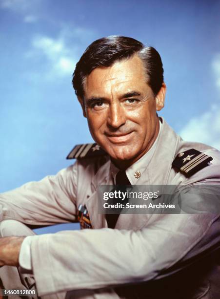 Cary Grant posing in US Navy uniform in a promotional portrait for the comedy 'Operation Petticoat', 1959.