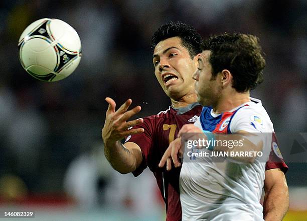 Venezuelan Nicolas Fedor and Chilean Jose Rojas vie for the ball during their Brazil 2014 FIFA World Cup South American qualifier match, held at the...