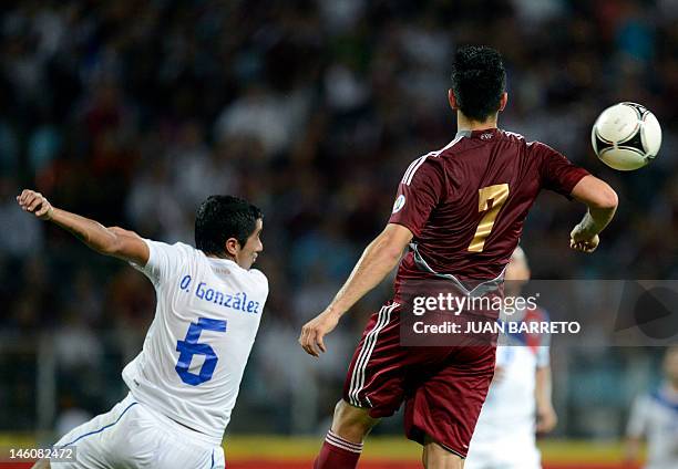 Venezuelan Nicolas Fedor and Chilean Osvaldo Gonzalez vie for the ball during their Brazil 2014 FIFA World Cup South American qualifier match held at...