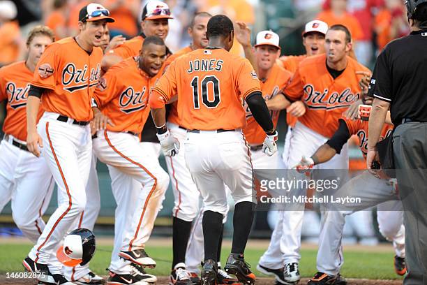 Adam Jones of the Baltimore Orioles celebrates a two run walk off home run in the twelfth during a interleague baseball game against the Philadelphia...