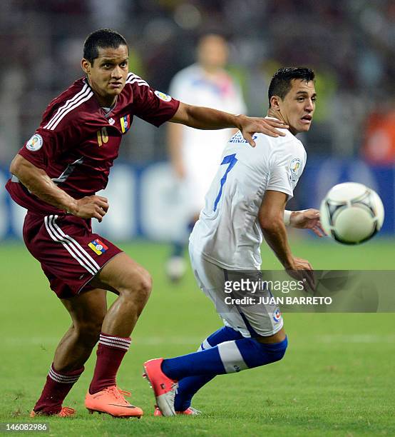 Venezuelan Roberto Rosales vies for the ball with Chilean Alexis Sanchez, during their Brazil 2014 FIFA World Cup South American qualifier match held...