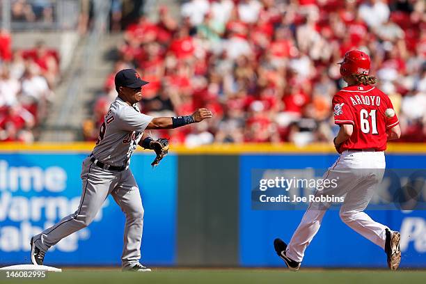 Ramon Santiago of the Detroit Tigers throws to first to turn a double play against Bronson Arroyo of the Cincinnati Reds at Great American Ball Park...