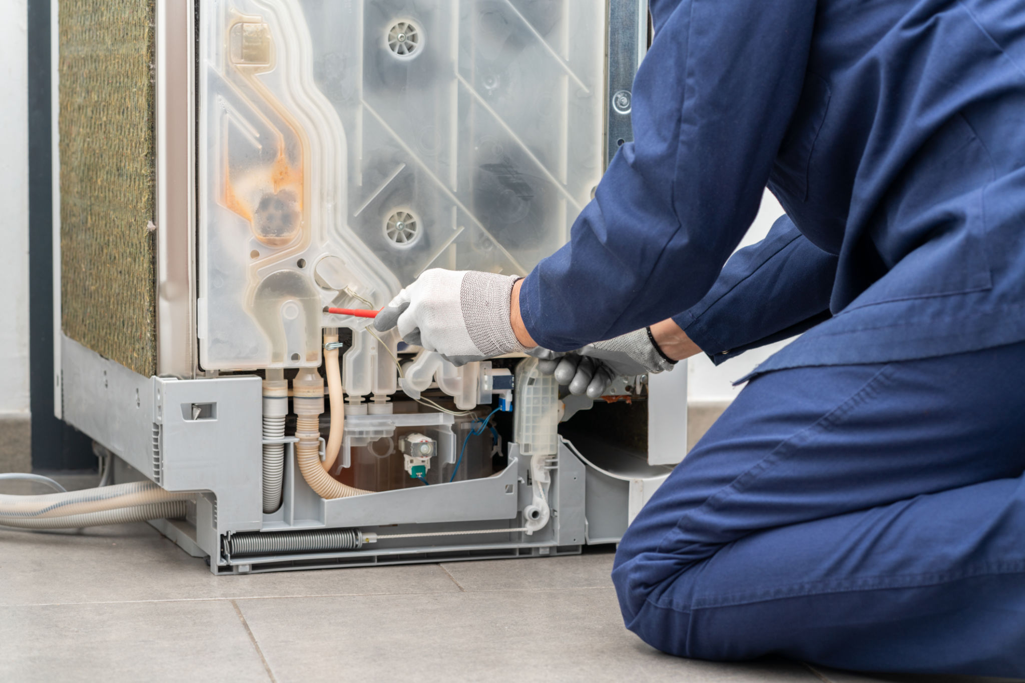 technician repairing refrigerator