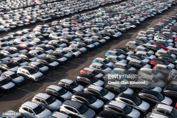 New cars sit at Tilbury Docks on January 30, 2023 in Tilbury, England. The ten percent drop in car manufacturing last year comes as car production in...