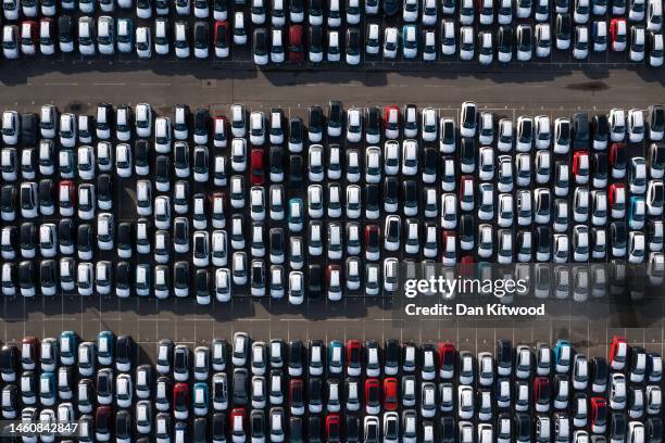 New cars sit at Tilbury Docks on January 30, 2023 in Tilbury, England. The ten percent drop in car manufacturing last year comes as car production in...