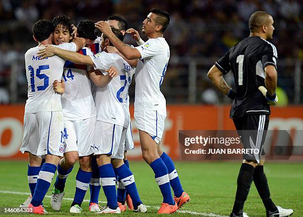 Chilean players celebrate after scoring against Venezuela during their Brazil 2014 FIFA World Cup South American qualifier match held at the Jose...