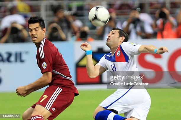 Nicolas Fedor fights for the ball with Jose Rojas during the match between Venezuela and Chile at Jose Antonio Anzoategui Stadium on June 09, 2012 in...