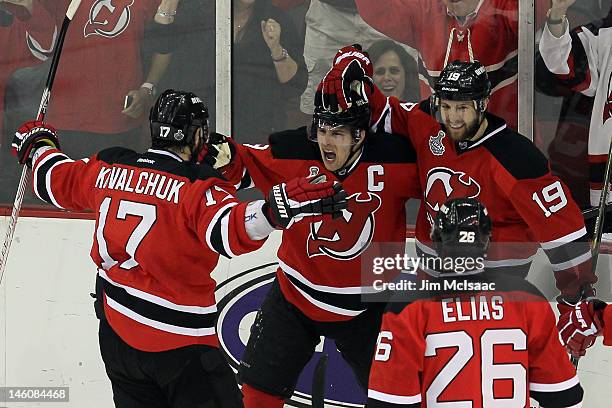 Zach Parise of the New Jersey Devils celebrates with teammates Ilya Kovalchuk, Patrik Elias and Travis Zajac after Parise scores a goal in the first...