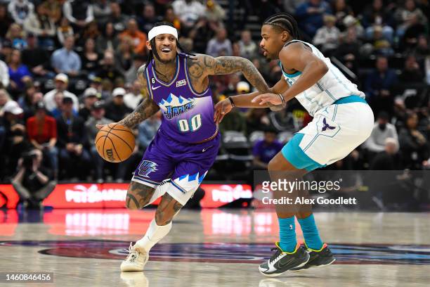 Jordan Clarkson of the Utah Jazz drives around Dennis Smith Jr. #8 of the Charlotte Hornets during the first half of a game at Vivint Arena on...