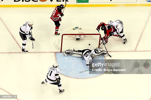 Zach Parise of the New Jersey Devils scores a goal against Jonathan Quick of the Los Angeles Kings in the first period as Matt Greene, Patrik Elias,...