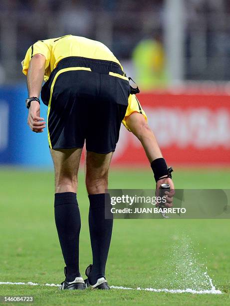 Colombian referee Jorge Guitriago marks the field during the Brazil 2014 FIFA World Cup South American qualifier match between Venezuela and Chile...