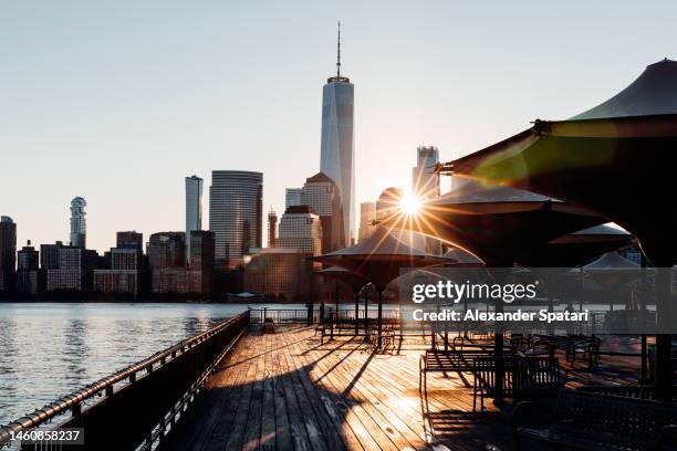 new york city skyline seen from pier in jersey city, usa - jersey city stock pictures, royalty-free photos & images