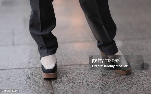 Farah Assaad seen wearing Ezzat official grey suit, white / black Ezzat official boots during Paris Fashion Week on January 26, 2023 in Paris, France.