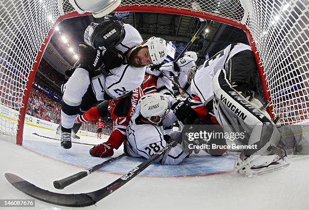 Dustin Penner, Jarret Stoll and Jonathan Quick of the Los Angeles Kings pile up in front of the goal against Ilya Kovalchuk and Adam Henrique of the...