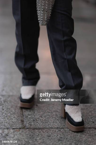 Farah Assaad seen wearing Ezzat official grey suit, white / black Ezzat official boots during Paris Fashion Week on January 26, 2023 in Paris, France.