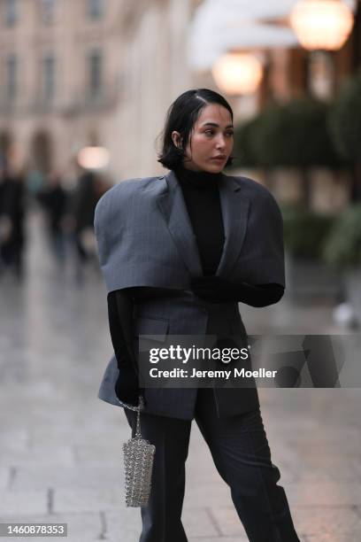 Farah Assaad seen wearing Ezzat official grey suit, small silver Ezzat official bag during Paris Fashion Week on January 26, 2023 in Paris, France.