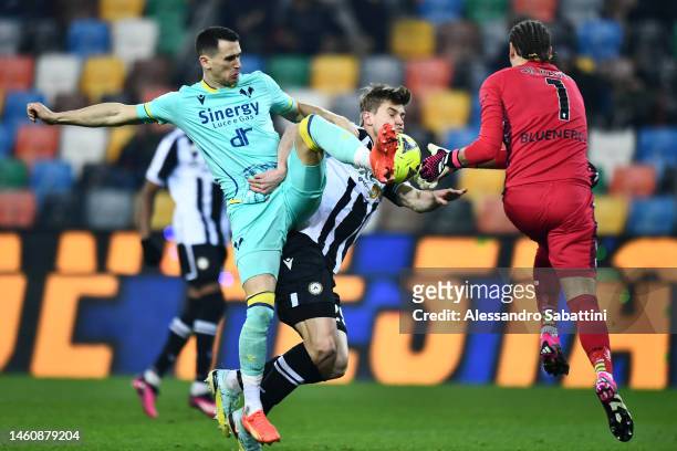 Kevin Lasagna of Hellas Verona battles for the ball with Jaka Bijol and Marco Silvestri of Udinese during the Serie A match between Udinese Calcio...