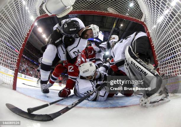 Dustin Penner, Jarret Stoll, Willie Mitchell and Jonathan Quick of the Los Angeles Kings fight for position against Ilya Kovalchuk and Adam Henrique...