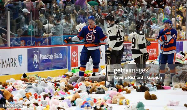 Dylan Mcilrath of the Hershey Bears and teammate Mike Vecchione talk to Seth Helgeson of the Bridgeport Islanders and his teammate Cole Bardreau at...