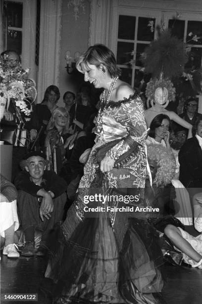 Designer Zandra Rhodes wearing a printed off-the-shoulder dress with ruffled trim after her charity fashion show for the Newsvendor's Benevolent Fund...