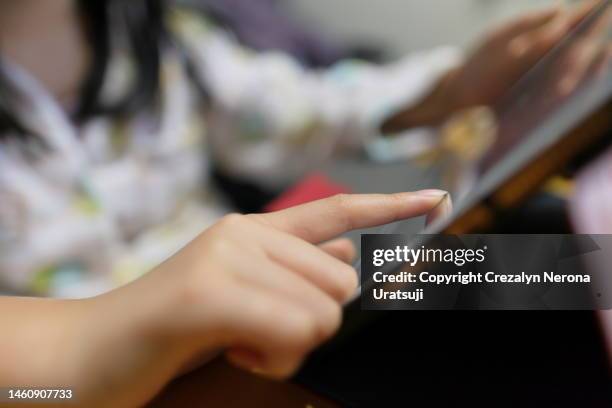 close up of finger touching the tablet screen - tapping stock pictures, royalty-free photos & images