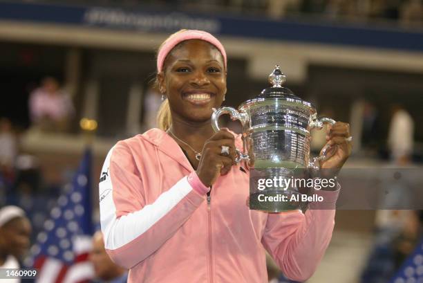 Serena Williams poses with her winning trophy after the finals at the US Open September 7, 2002 at the USTA National Tennis Center in Flushing...