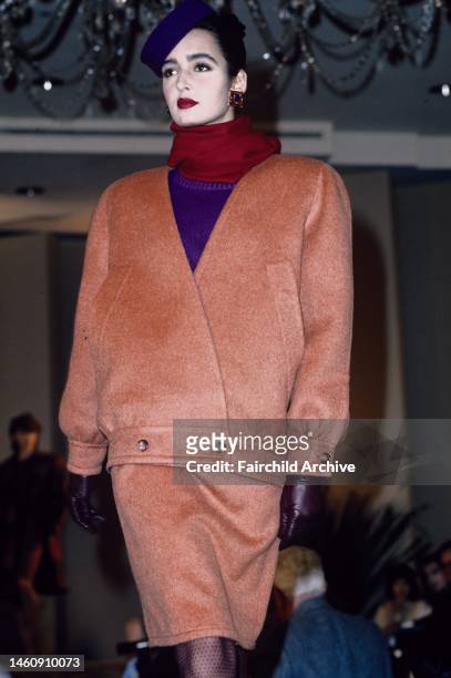 Peach crossover coat with matching skirt and purple blouse in the Bill Blass Fall 1985 RTW show