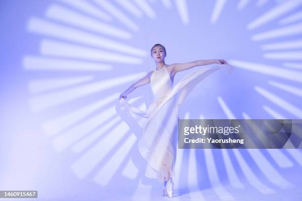 young asian woman dancing in graceful pose - china athlete woman stock-fotos und bilder