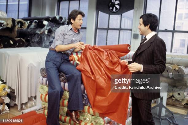 Business partners, fashion designer Calvin Klein and label executive Barry Schwartz, talking in a loft filled with reams of fabric
