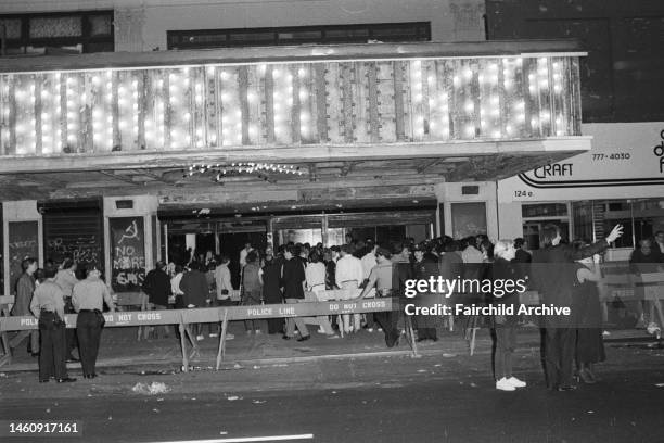 People waiting in line to attend the party at the Palladium, designed by Japanese architect Arata Isozaki and filled with art installations and...