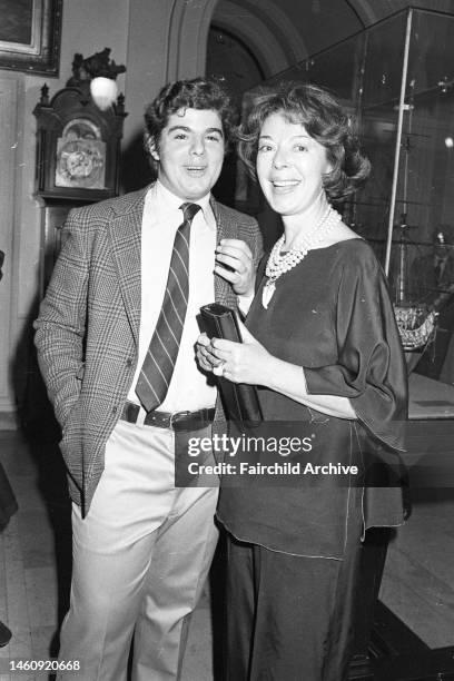 Journalist Shirley Clurman in a black pantsuit with clutch stands beside Richard Michael at the New York City Yacht Club in 1976 for Pat Buckley's...