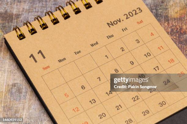 calendar desk 2023: november is the month for the organizer to plan and deadline with a grunge paper background. - november fotografías e imágenes de stock