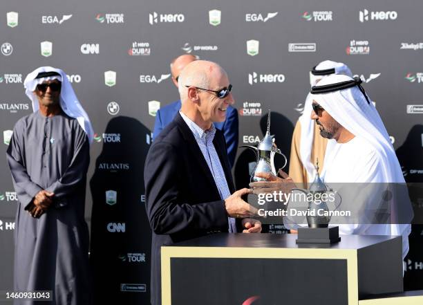 Mike Stewart of Scotland the DP World Tour Tournament Director of The Dubai Desert Classic is presented wit a special replica trophy to mark his...