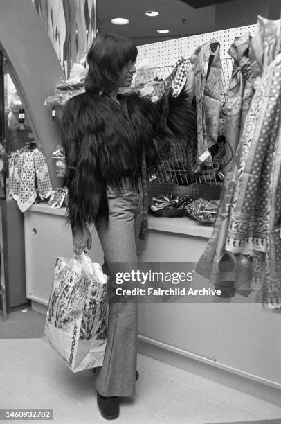 Woman carrying a Bloomingdale's bag, shopping at Macy's department store in the Christmas season