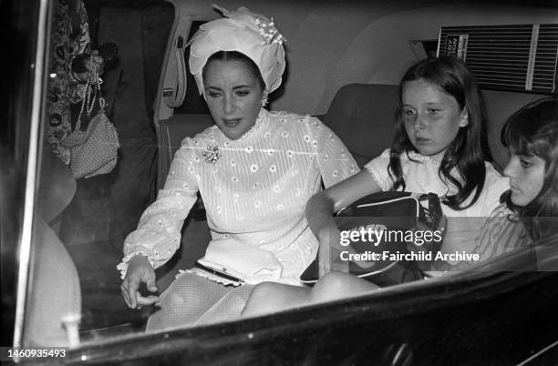 Elizabeth Taylor in car with daughters Liza Todd, Maria and Kate Burton, arriving by ship in New York