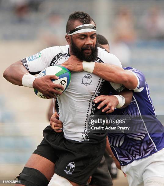 Api Naikatini of Fiji is tackled during the IRB Pacific Nations Cup match between Fiji and Samoa at Prince Chichibu Memorial Stadium on June 10, 2012...