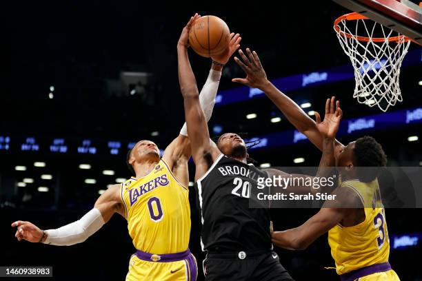 Day'Ron Sharpe of the Brooklyn Nets grabs a rebound as Russell Westbrook and Thomas Bryant of the Los Angeles Lakers defend during the second half at...