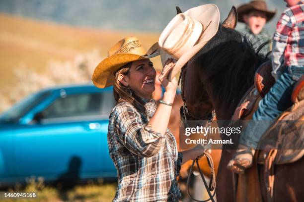 proud mother enjoying a day in the rodeo with son - gymnastics vault stock pictures, royalty-free photos & images