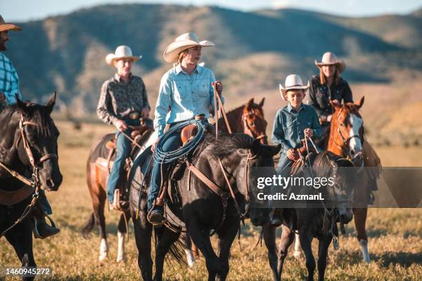 happy big family enjoying horse riding together - horseback riding stock pictures, royalty-free photos & images