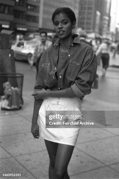 Model wearing a denim top and mini-skirt by Calvin Klein Jeans in the garment district of Manhattan.