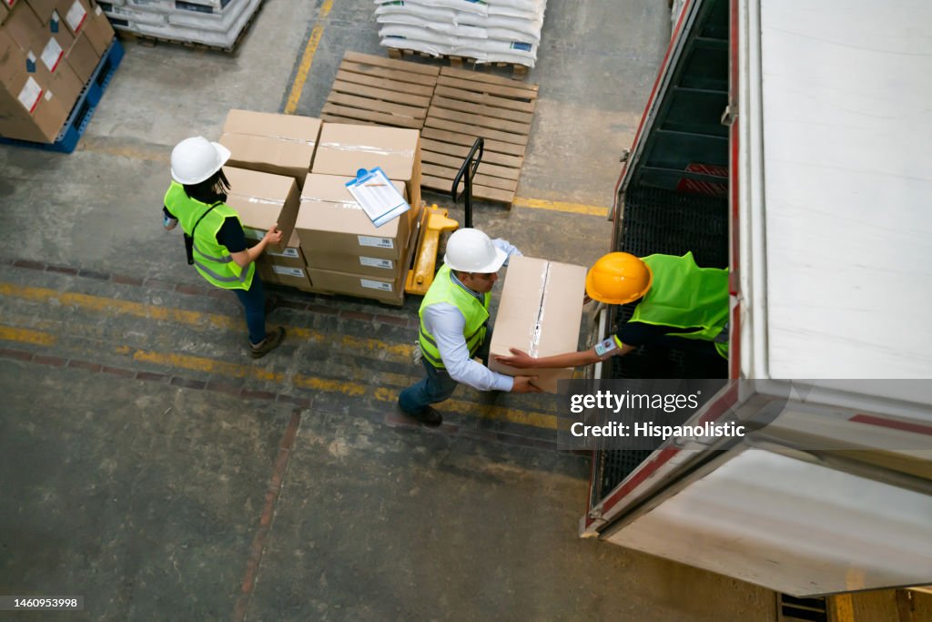 Group of warehouse workers loading a truck with boxes