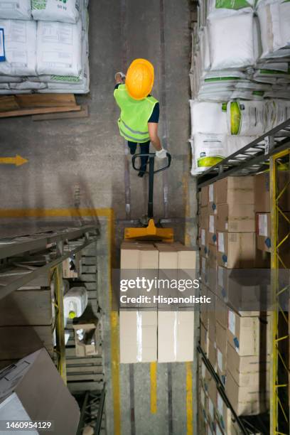 warehouse worker moving boxes using a forklift - ware house worker forklift stock pictures, royalty-free photos & images