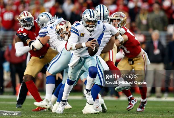 Dak Prescott of the Dallas Cowboys scrambles and runs with the ball during an NFL divisional round playoff football game between the San Francisco...