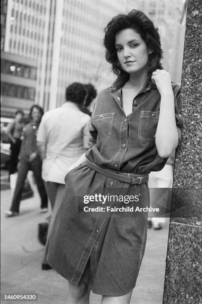 Model wearing a denim shirt dress from the Calvin Klein Jeans collection on Seventh Avenue in Manhattan's garment district. The dress moves into...