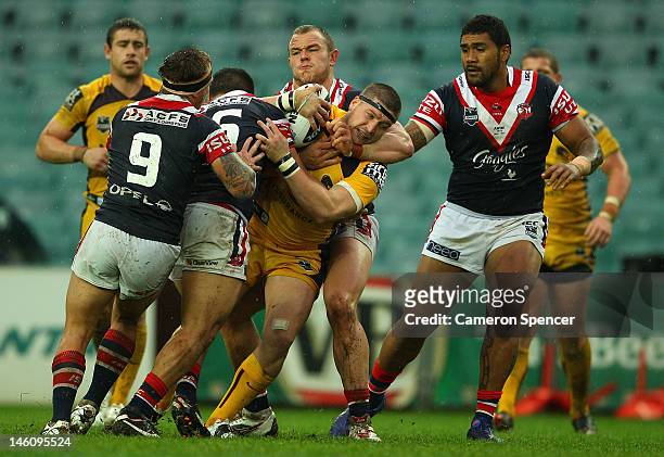 Scott Anderson of the Broncos is tackled during the round 14 NRL match between the Sydney Roosters and the Brisbane Bronocs at Allianz Stadium on...